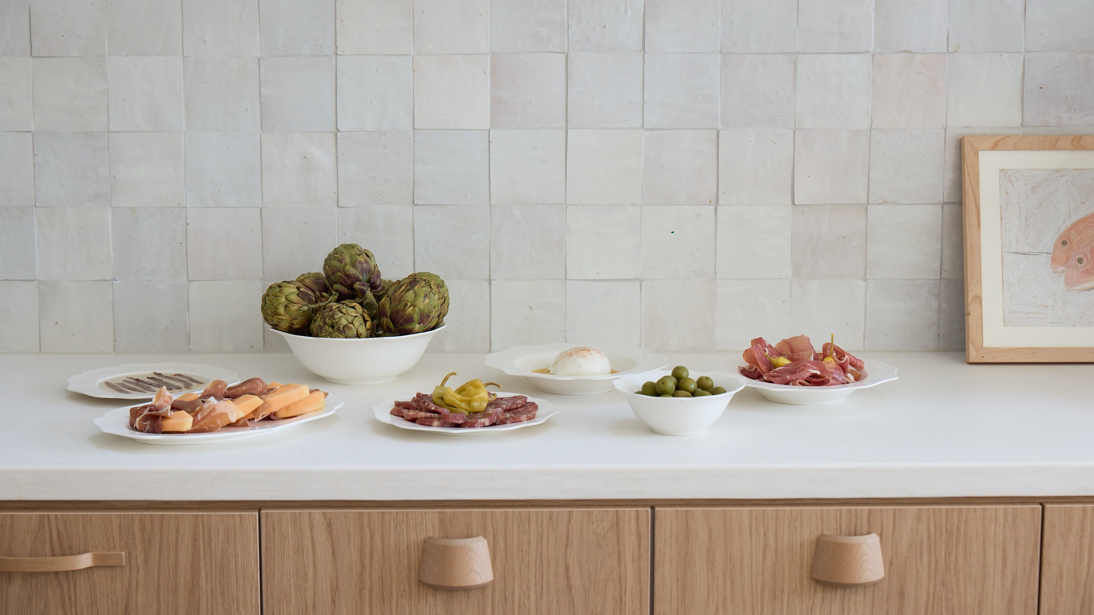 Kitchen counter with food items and a tiled wall.