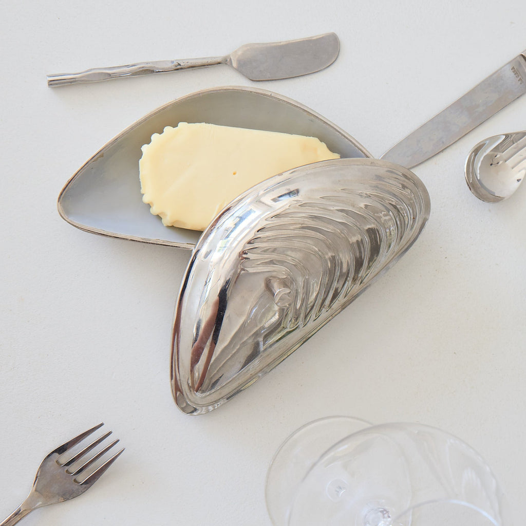 Silver plating with cutlery on a white tablecloth
